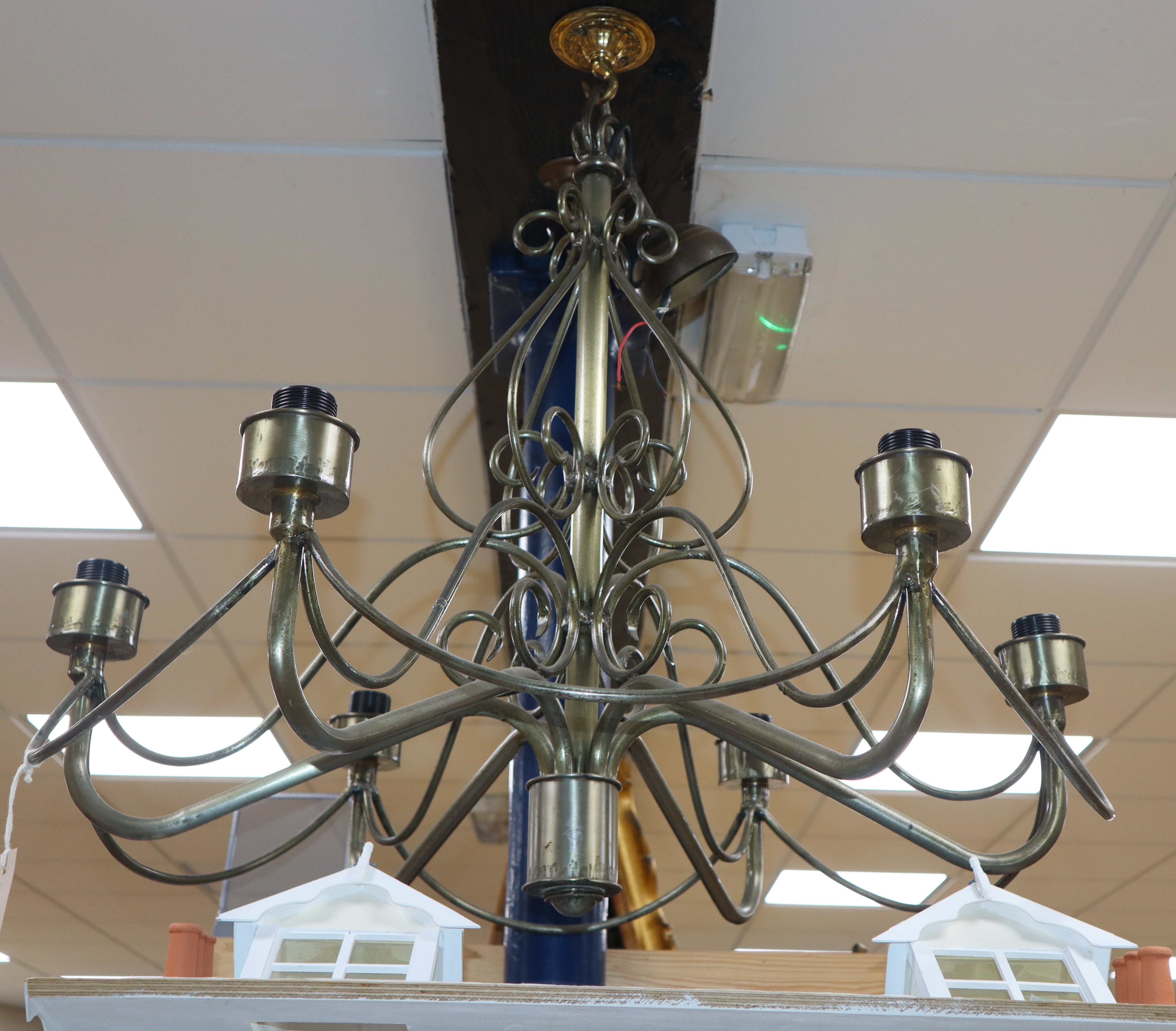 A wrought metal six branch ceiling light